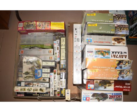 A collection of army related Airfix models BY Airfix, Heller and Tamiya, in two boxes.