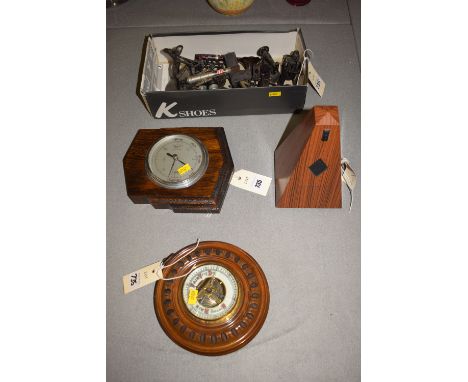 A modern metronome in plastic case, simulated wooden case; two barometers; a collection of pencil sharpeners.