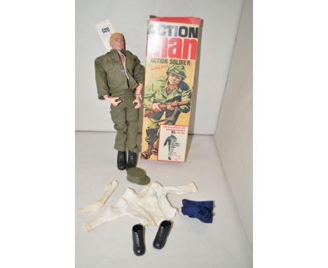 A 1964 Action Man, by Palitoy, blonde hair, in combat gear; together with a small quantity of other clothing, boxed.