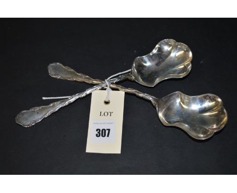 A pair of silver serving spoons, by Henry Wilkinson, Sheffield 1904, with leaf decorated stem, 4oz.