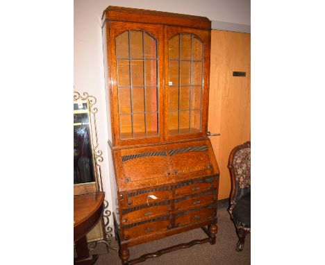 An early 20th Century oak bureau bookcase with leaded glass panel doors, 35in. wide.
