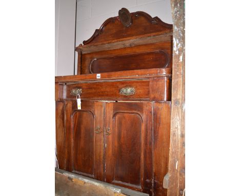 A Victorian mahogany chiffonier, the shaped panel back fitted a shelf, 34in. wide.