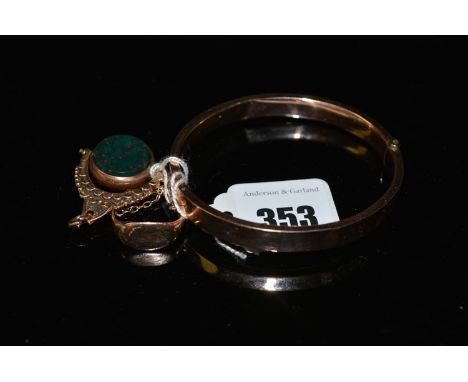 A 9ct. yellow gold half engraved bangle, 10.1grms together with a yellow metal signet ring; and a bloodstone set 9ct. yellow 