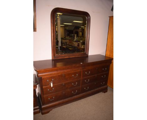 A reproduction stained wood dressing chest, comprising: an arched bevelled mirror over a base containing two flights of four 