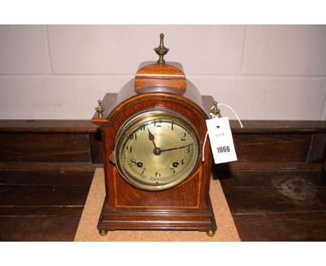 A late 19th Century mantel clock in arched inlaid mahogany case, the silvered arabic dial inscribed "Grant & Son, South Shiel