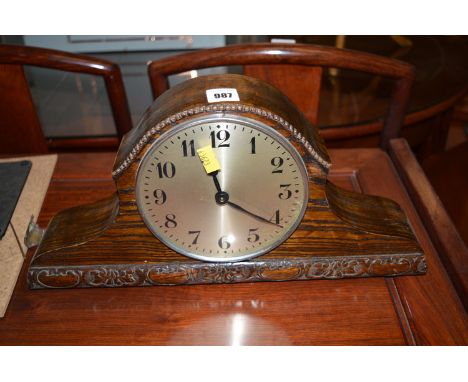 A mantel clock in oak case.