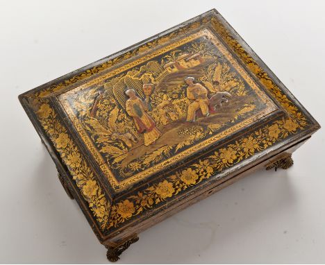 A 19th Century lacquer and gilt sarcophagus form games box, the lid panel depicting figures in a landscape flanked by ring ha
