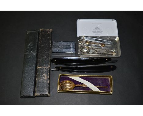 A giltmetal coronation anointing spoon, boxed; a Colibri lighter; two cut-throat razors; and other items.