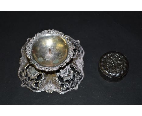 A German silver dwarf candlestick, the central pricket surrounded by rose and scroll design; together with a pill pot, 800 st