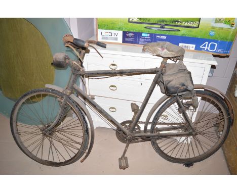 A vintage gent's Hercules bicycle, with original lights and saddle bags (distressed).