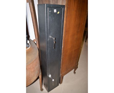 A painted metal gun security cabinet with two pairs of keys, 52in. high.