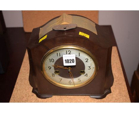A chiming mantel clock in bakelite case.