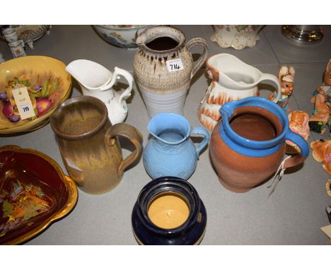 Six ceramic jugs; a florally decorated tobacco jar; and a pair of folding opera glasses.
