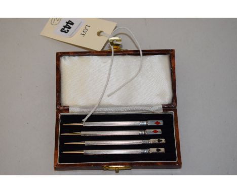 A set of four sterling silver propelling bridge pencils, enamel suits to ends, cased.