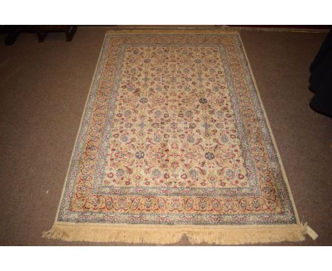 A Kashmiri rug, the scrolling floral field on ivory ground, 175 x 119cms.