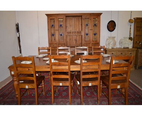 A large modern Asian stained pine kitchen dining suite, comprising: a dresser fitted cupboards and drawers, 79 x 54in. high; 