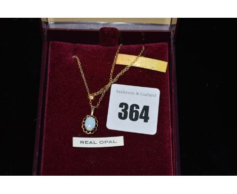 An opal pendant in 9ct. yellow gold, on chain.