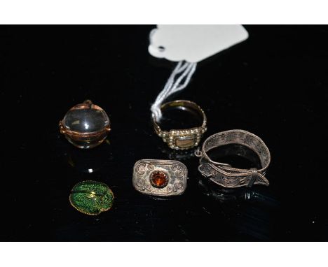 Items of jewellery, including: a filigree scarf ring; an antique seed pearl set memorium ring; a glass sphere pattern pendant