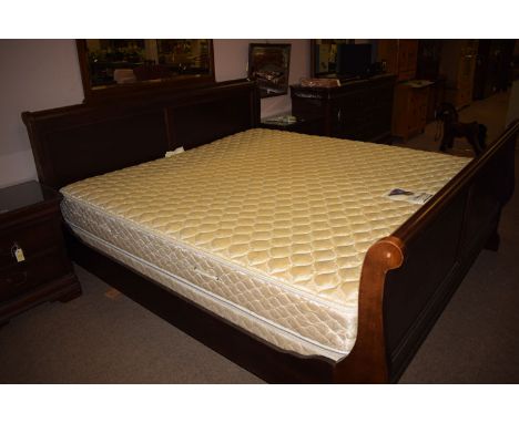 A very large stained wood sleigh style bedstead, complete with base and mattress.NBThis item matches with Lot 1021.