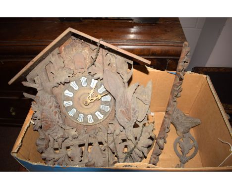 A 19th Century cuckoo clock, in ornate carved wooden case adorned with carved leaves, a fox and a bird.
