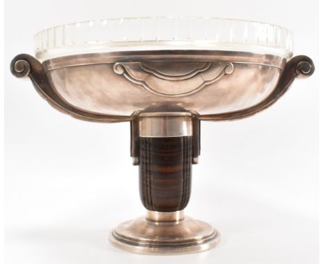 A 1930's Art Deco silver plated table centre piece tazza bowl having a cut glass insert with scrolled handles raised on a car