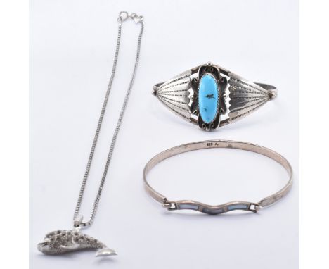 Two silver bangles together with a 925 silver pendant necklace. The necklace strung with a rhinestone set dolphin with enamel