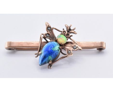 A 19th Century 9ct gold bug brooch having a flat topped bar brooch with an applied insect set with on oval opal cabochon to t