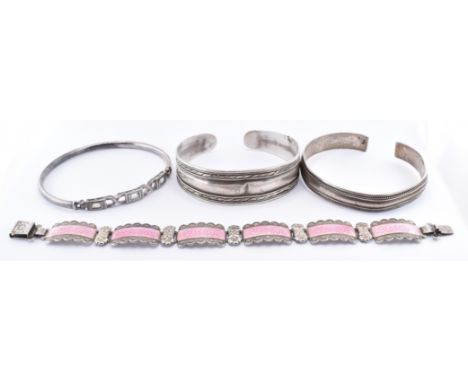 A group of four silver bracelets to include a pink enamelled bracelet having enamel floral decoration (marked Harmony to the 