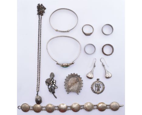 A collection of silver and white metal jewellery to include a 19th Century Victorian Mizpah brooch in the form of a horse sho