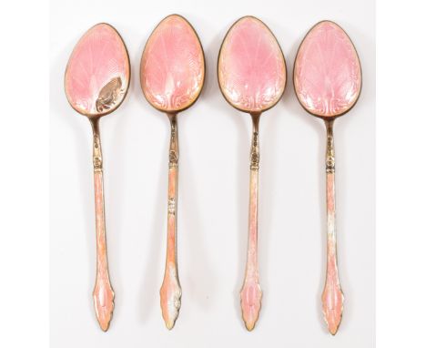 A set of four early 20th Century continental silver and enamel tea spoons having pointed bowls and pink guilloche enamel thro