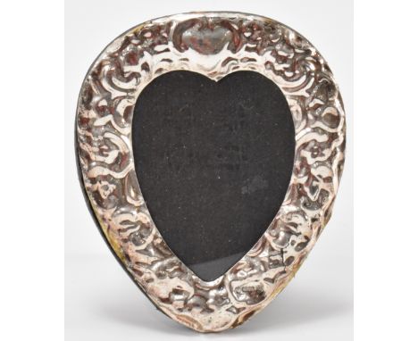 A silver fronted photo frame in the form of a heart with an easel back. Assay marked Birmingham 925. Measures 8cm tall. Weigh