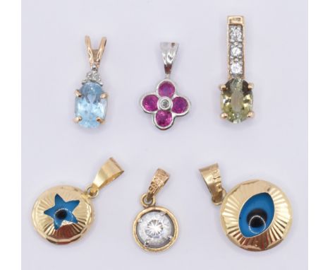 A group of five gold pendants to include a 14ct gold white stone pendant, a pair of 14ct gold blue eye pendants, a 9ct white 