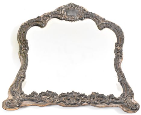 An Edwardian William J Holmes silver fronted mirror having repousse decoration with scrolled foliates and bevelled glass mirr