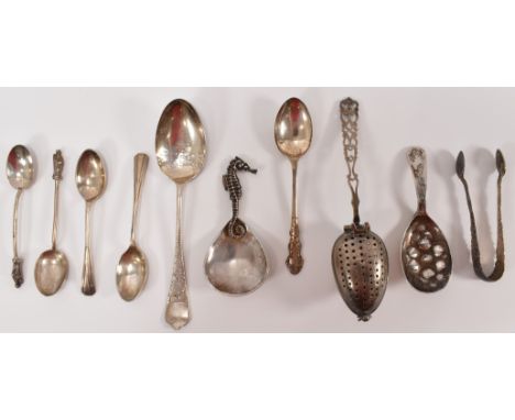 A collection of mixed 20th Century silver hallmarked table ware to include two tea caddy spoons, a tea strainer spoon, a pair