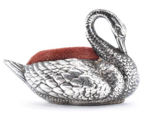 An early 20th Century Edwardian silver hallmarked pin cushion in the form of a swan having a red velvet cushion to the back. 