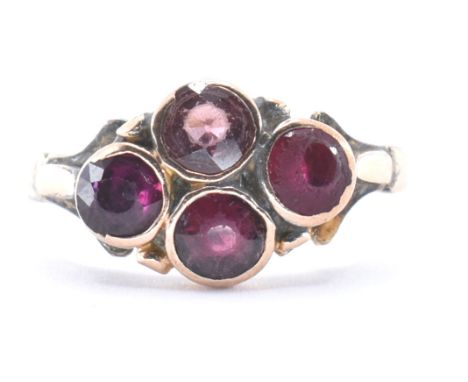 An 18ct gold cluster ring. The ring set with four red stones including ruby. Unmarked tests indicate 18ct gold.&nbsp; Weight 