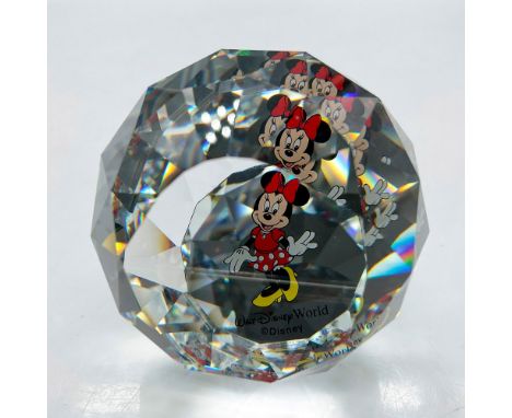 Faceted crystal globe decorated with a smiling Minnie giving a wave with her gloved hands. Colored in black, white and red wi