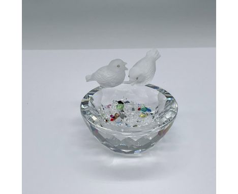 Figure of two satin crystal birds on a clear crystal bowl. The base has three crystal feet on the bottom. Includes tiny color