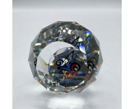 Faceted crystal polygon decorated with Sorcerer's Hat and gloved hand. Colored in blue, red and yellow. Felt bottom covers ba