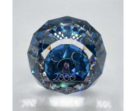 Faceted round crystal adorned with deep blue coloration with the castle in background, Disneyland Paris 2000 imprinted in des