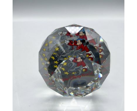 Clear faceted crystal globe decorated with Mickey the Sorcerer in colorful background created for the anniversary of Walt Dis