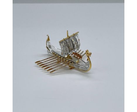 This clear crystal and gold detailed Viking ship was part of the Journey's collection. It sits upright on a tiny gold stand. 