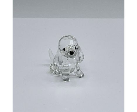 Puppy is sitting at attention. It has a clear cut crystal body with black eyes and nose, and a frosted tail. This item has it