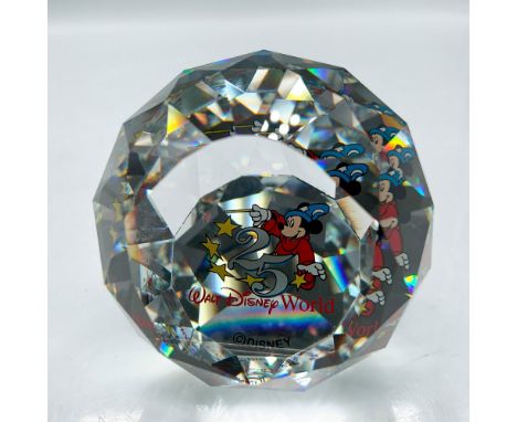 Clear faceted crystal globe decorated with Mickey the Sorcerer in colorful background created for the anniversary of Walt Dis
