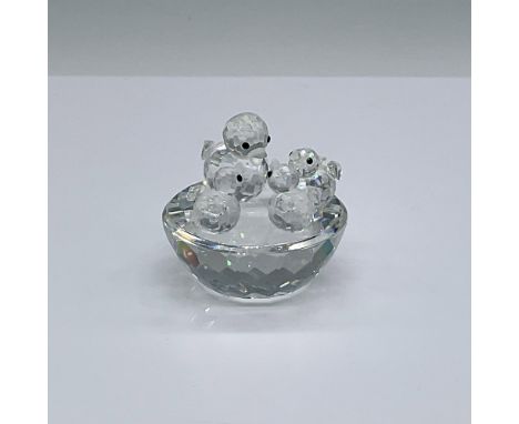 Mother bird feeding three babies resting on top of a bowl. Clear faceted bodies with frosted beaks and black eyes. Swarovski 