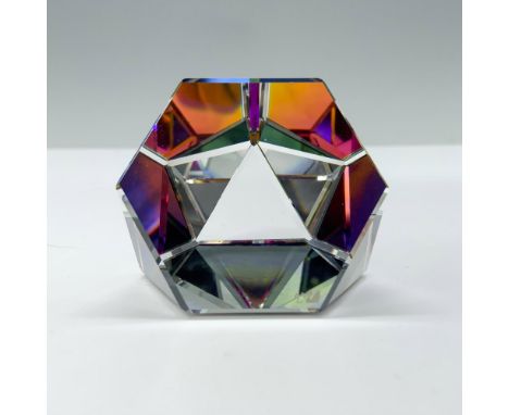 A dazzling paperweight crafted from hexagonal and triangular facets, shimmering with a captivating array of rainbow colors. S