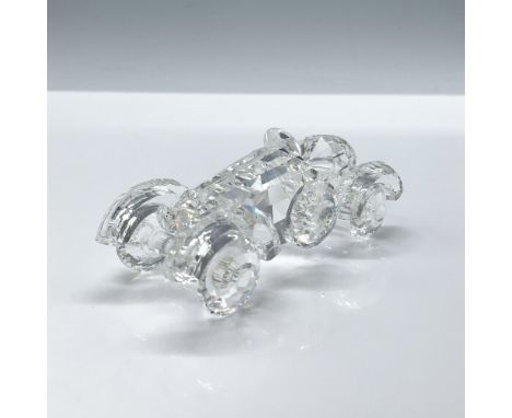 A stunning clear crystal vehicle made to resemble 20th century cars that features rounded wheel edges and a sleek single seat