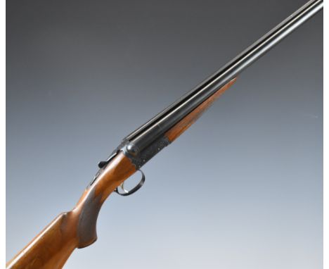 SKB Model 200E 12 bore side by side shotgun with engraved lock, trigger guard, underside, top plate, thumb lever and fences, 