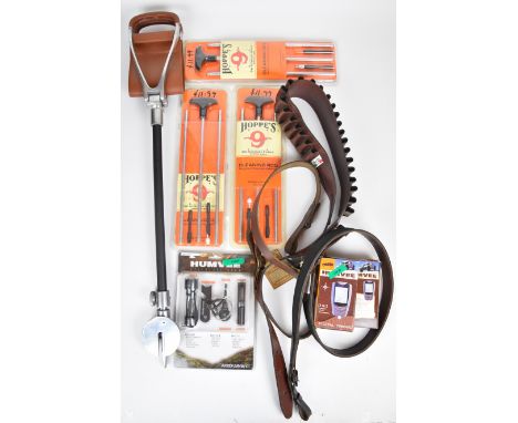 A collection of gun and shooting related items including leather shotgun cartridge belt, leather rifle sling, three Hoppe's g