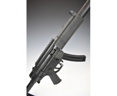 German Sport Guns (GSG) 522 .22 semi-automatic assault style rifle with textured pistol grip, tactical stock, three curved mu